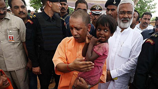 Uttar Pradesh Chief Minister Yogi Adityanath along with Uttar Pradesh BJP State president Swatantra Dev Singh meets with the Umbha Village incident dead and injured victim's family in Village in Sonbhadra on Sunday.(ANI Photo)