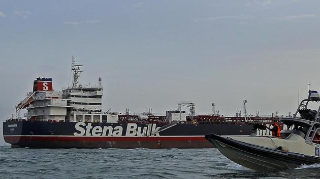 A speedboat and a helicopter of the Iran's Revolutionary Guard move around a British-flagged oil tanker Stena Impero which was seized on Friday by the Guard, in the Iranian port of Bandar Abbas, Sunday, July 21, 2019.(AP)