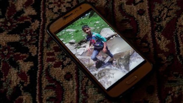 A photograph of Atif is seen on his father’s phone. Atif was eventually killed in crossfire between the militants and troops. The family said they had never seen the men before, who did not explain why they had taken hostages. (Danish Siddiqui / REUTERS) A photograph of Atif is seen on his father’s phone. Atif was eventually killed in crossfire between the militants and troops. The family said they had never seen the men before, who did not explain why they had taken hostages. (Danish Siddiqui / REUTERS)