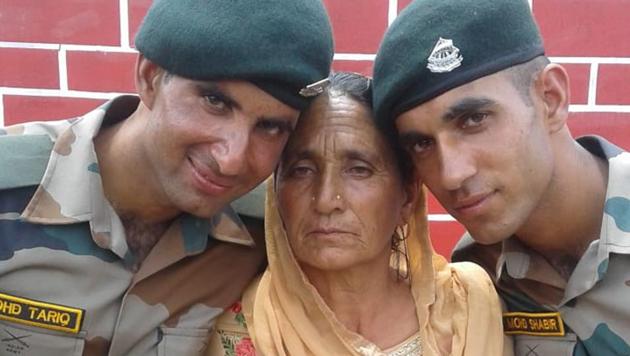 Tariq and Shabbir posing with their mother Raaj Begum during an enrollment rally in Rajouri on Monday.(HT photo)