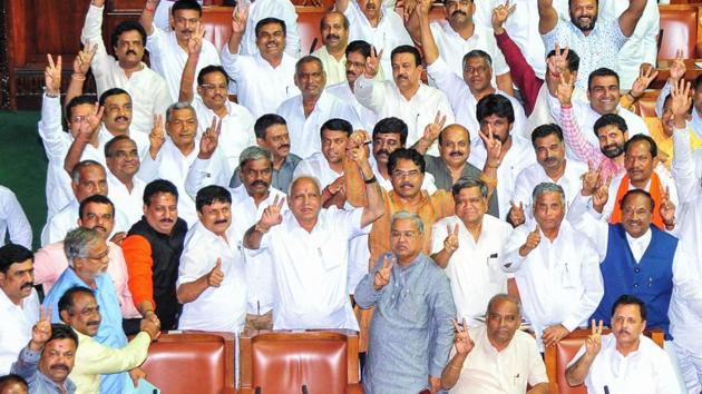 Former Chief Minister of Karnataka and BJP leader BS Yeddyurappa shows victory sign along with other members after the defeat of Congress-JD(S) coalition government at Vidhana Soudha in Bengaluru on Tuesday. (ANI Photo)