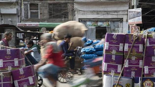 Workers transport goods at Khari Baoli spice market in New Delhii. India will still be the fastest growing major economy of the world and much ahead of China, Washington-based global financial institution said.(Bloomberg file photo)