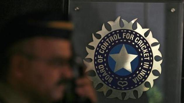 A policeman walks past a logo of the Board of Control for Cricket in India (BCCI).(REUTERS)