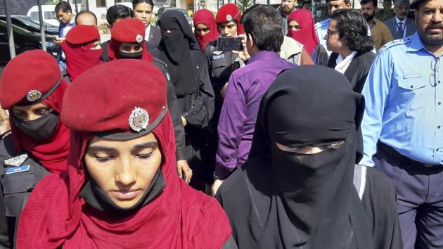 File photo of Pakistani Hindu girls wearing black veils, arriving at a court in Islamabad in March for a hearing after two teenage sisters from the minority community were allegedly abducted and forced to convert and marry two Muslim men.(AP)