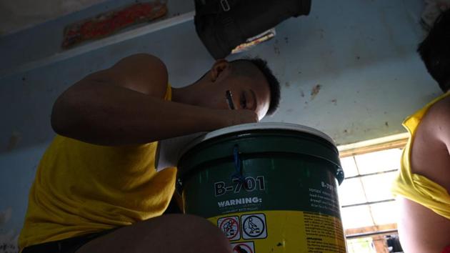 A minor held at a juvenile detention centre writes on top of a paint container. Tristan, 15, was relieved when he was transferred to a House of Hope in Manila after being held in an adult jail on a drug trafficking charge he said police fabricated. “I thought it would be a lovely home. But it was also a prison, a prison for children,” he said. (Ted Aljibe / AFP) A minor held at a juvenile detention centre writes on top of a paint container. Tristan, 15, was relieved when he was transferred to a House of Hope in Manila after being held in an adult jail on a drug trafficking charge he said police fabricated. “I thought it would be a lovely home. But it was also a prison, a prison for children,” he said. (Ted Aljibe / AFP)