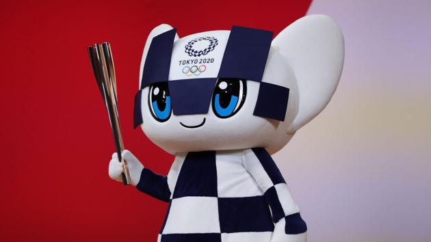 Miraitowa, the mascot for the Tokyo 2020 Olympic Games, holds an Olympic torch during the marking of one year ceremony before the start of the games. Miraitowa based on the Japanese words mirai (future) and towa (eternity) combined. This name was chosen to promote a future full of eternal hope in the hearts of people all over the world. (Behrouz Mehri / AFP) Miraitowa, the mascot for the Tokyo 2020 Olympic Games, holds an Olympic torch during the marking of one year ceremony before the start of the games. Miraitowa based on the Japanese words mirai (future) and towa (eternity) combined. This name was chosen to promote a future full of eternal hope in the hearts of people all over the world. (Behrouz Mehri / AFP)