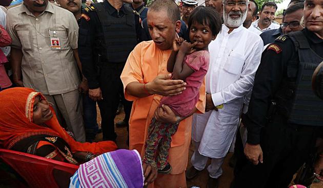 Uttar Pradesh Chief Minister Yogi Adityanath meets with the kin of those killed over a land dispute in Umbha village, Sonbhadra, on Sunday, July 21, 2019.(ANI)