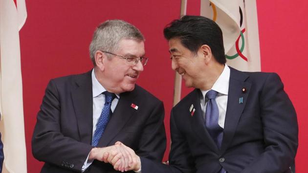 International Olympic Committee (IOC) President Thomas Bach, left, shakes hands with Japanese Prime Minister Shinzo Abe during the‘One Year to Go’ Olympic ceremony. (Koji Sasahara / AP) International Olympic Committee (IOC) President Thomas Bach, left, shakes hands with Japanese Prime Minister Shinzo Abe during the‘One Year to Go’ Olympic ceremony. (Koji Sasahara / AP)