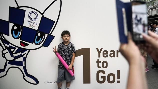 A boy pauses for photos during a One Year to Go ceremony held at Tokyo International Forum.(AP)