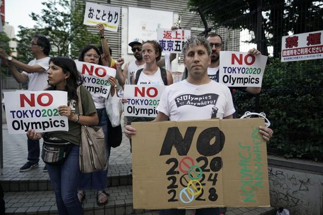Anti-Olympics protesters hold placards during a rally outside Shinjuku Station. The group fighting against the games is known as Okotowari Olympics 2020, or No Thanks Olympics 2020. Their concerns are based on the recent history of what happens to a city after the Olympics descend: debt, displacement, and hyper-militarization. (Jae C. Hong / AP) Anti-Olympics protesters hold placards during a rally outside Shinjuku Station. The group fighting against the games is known as Okotowari Olympics 2020, or No Thanks Olympics 2020. Their concerns are based on the recent history of what happens to a city after the Olympics descend: debt, displacement, and hyper-militarization. (Jae C. Hong / AP)