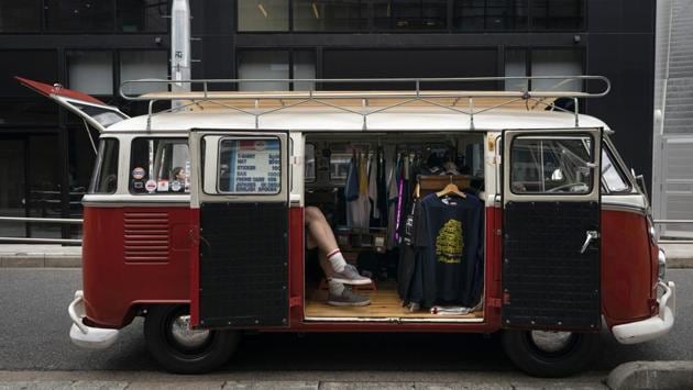 Bruce McCullough, who moved to Japan 22 years ago from Vancouver, Canada, sits in his mobile clothing store in the Shibuya district of Tokyo. (Jae C. Hong / AP)
