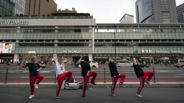 A Japanese dance and vocal group called Banquet performs on the street outside Shinjuku Station. (Jae C. Hong / AP)