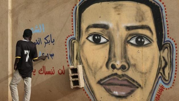 A man walks past the mural painting of Babikir Anwar on the wall of the family home in the neighbourhood of Shambat. “Graffiti makes martyrs come alive and reminds people of them even if the people themselves did or did not support the revolution,” said Sudanese artist Assil Diab. (Ashraf Shazly / AFP)