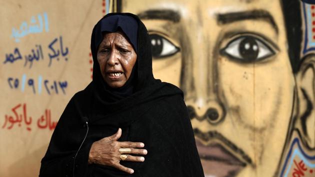Adawiya Mohamed, the mother of Babikir Anwar is pictured in front of her son’s mural painting on the wall of the family home. For years such artwork remained underground amid censorship imposed by heavy-handed security agents of Bashir’s regime, who considered it anti-establishment or pure vandalism. (Ashraf Shazly / AFP)