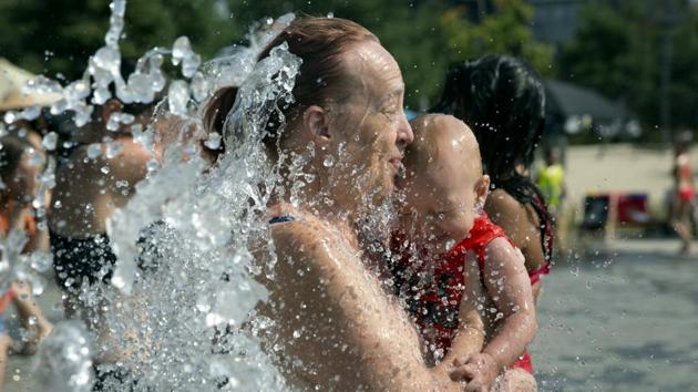 A mother and child cool off at a fountain in Antwerp, Belgium, on Thursday as an extreme heat alert was sounded. (AP Photo) A mother and child cool off at a fountain in Antwerp, Belgium, on Thursday as an extreme heat alert was sounded. (AP Photo)