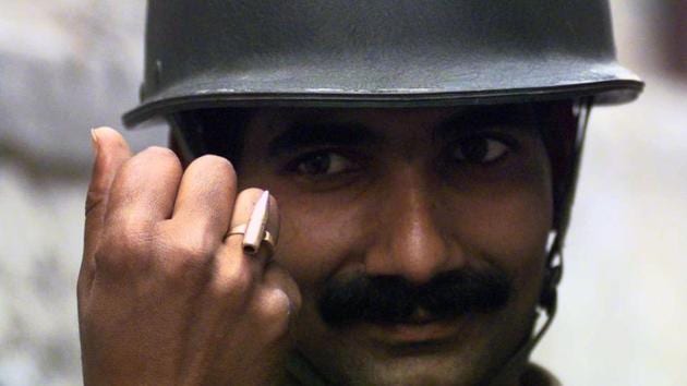 A soldier proudly displays his ring made out of a LMG bullet in Kargil. The recapture of Tiger Hill figured as an important objective due to its strategic advantage as the highest peak in the Kargil-Drass sector. India meanwhile launched strengthened efforts to reclaim its territories throughout June. (Manish Swarup / HT Archive) 