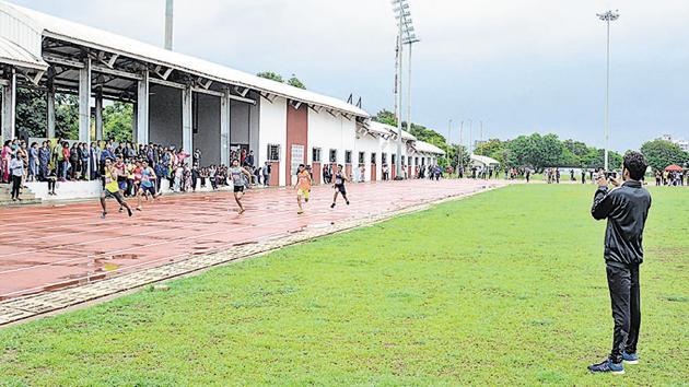 A spectator taking a video of athletes in action at the Pune District Amateur Athletics Championship at Shiv Chhatrapati sports complex, Balewadi, on Friday.(Milind Saurkar/HT Photo)