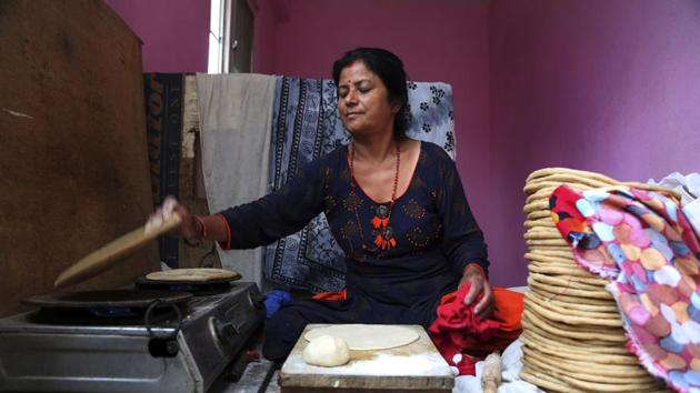 Saraswati Dangol prepares roti to feed monkeys near Pashupatinath temple. (Niranjan Shrestha / AP)
