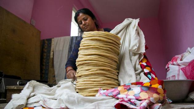 Saraswati wraps rotisserie after preparing them for monkeys. She buys some 10 kilograms (22 pounds) of flour and spends hours cooking the roti, traveling to the forest temple and feeding them daily. (Niranjan Shrestha / AP)