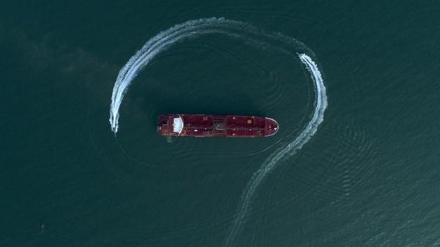 Speedboats from Iran's Revolutionary Guard circle the British-flagged oil tanker Stena Impero in the Iranian port of Bandar Abbas, after it was seized in the Strait of Hormuz two days earlier. Iran's president, Hassan Rouhani, suggested Wednesday that Stena Impero could be released if the U.K. takes similar steps to hand back an Iranian oil tanker seized by the Royal Navy off Gibraltar earlier this month. (Morteza Akhoondi / AP) Speedboats from Iran's Revolutionary Guard circle the British-flagged oil tanker Stena Impero in the Iranian port of Bandar Abbas, after it was seized in the Strait of Hormuz two days earlier. Iran's president, Hassan Rouhani, suggested Wednesday that Stena Impero could be released if the U.K. takes similar steps to hand back an Iranian oil tanker seized by the Royal Navy off Gibraltar earlier this month. (Morteza Akhoondi / AP)