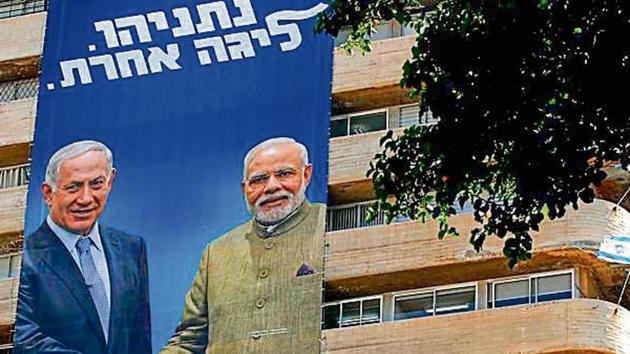 A Likud Party banner on a building in Tel Aviv shows Israeli PM Benjamin Netanyahu shaking hands with Indian PM Narendra Modi with a caption reading in Hebrew ‘in a different league’. (AFP photo)