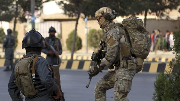 Afghan security personnel secure the site of an attack in Kabul, Afghanistan. Afghan officials say the political offices of the president's running mate were hit by a large explosion and stormed by an unknown number of attackers.(AP Photo) Afghan security personnel secure the site of an attack in Kabul, Afghanistan. Afghan officials say the political offices of the president's running mate were hit by a large explosion and stormed by an unknown number of attackers.(AP Photo)