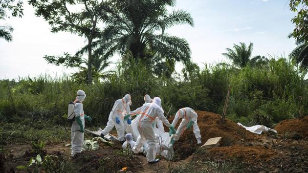 Workers bury the remains of Mussa Kathembo, an Islamic scholar who had prayed over those who were sick in Beni. When Kathembo fell ill he was taken from his house to the Ebola treatment centre. As he and his wife, who also fell ill, received emergency treatment from health workers dressed head-to-toe in hazmat suits, their house was quickly turned into a vaccination centre by local health authorities and the World Health Organisation. (Jerome Delay / AP) Workers bury the remains of Mussa Kathembo, an Islamic scholar who had prayed over those who were sick in Beni. When Kathembo fell ill he was taken from his house to the Ebola treatment centre. As he and his wife, who also fell ill, received emergency treatment from health workers dressed head-to-toe in hazmat suits, their house was quickly turned into a vaccination centre by local health authorities and the World Health Organisation. (Jerome Delay / AP)
