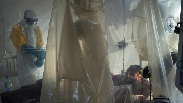 Health workers wearing protective gear check on a patient isolated in a plastic cube at an Ebola treatment centre in eastern Congo, the epicentre of the current Ebola epidemic. Many people in the outbreak area do not believe Ebola exists. Unfamiliar with the disease, they blame witchcraft, politicians and foreigners for the deaths. That makes things difficult and dangerous for those working to contain the outbreak. And once someone is infected, it is often too late. (Jerome Delay / AP) Health workers wearing protective gear check on a patient isolated in a plastic cube at an Ebola treatment centre in eastern Congo, the epicentre of the current Ebola epidemic. Many people in the outbreak area do not believe Ebola exists. Unfamiliar with the disease, they blame witchcraft, politicians and foreigners for the deaths. That makes things difficult and dangerous for those working to contain the outbreak. And once someone is infected, it is often too late. (Jerome Delay / AP)