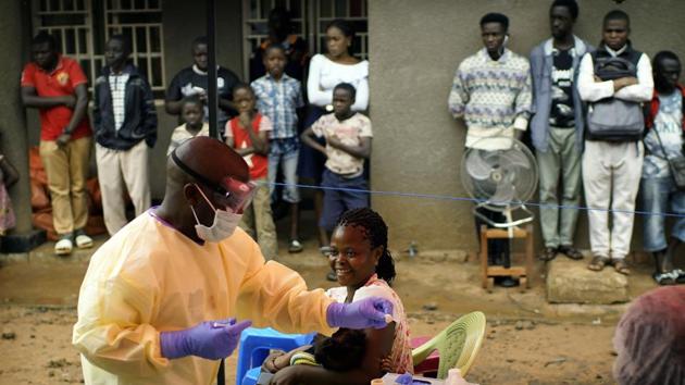 The new strategy of giving shots to anyone who wants them involves setting up “pop-up” sites in the neighbourhoods most affected. Last week a vaccination team headed to the neighbourhood in Beni where Nduhi’s wife had stayed after he died. Baraka Kathembo Makasi, a 22-year-old motorbike taxi driver, brought his wife and two children with him. “At first I refused,” he said, “but I started seeing people die and decided to go.” (Jerome Delay / AP) The new strategy of giving shots to anyone who wants them involves setting up “pop-up” sites in the neighbourhoods most affected. Last week a vaccination team headed to the neighbourhood in Beni where Nduhi’s wife had stayed after he died. Baraka Kathembo Makasi, a 22-year-old motorbike taxi driver, brought his wife and two children with him. “At first I refused,” he said, “but I started seeing people die and decided to go.” (Jerome Delay / AP)