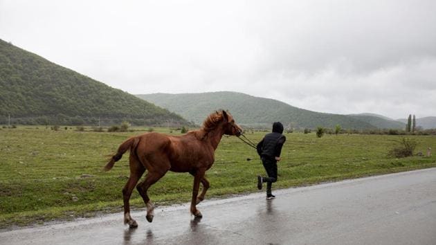 A boy takes his horse to Duisi village to take part in a horse race to commemorate death of one of the residents of Pankisi Gorge. The gorge is linked by mountain passes to the southern Russian region of Chechnya, and many of its inhabitants are ethnic Chechens. (Ekaterina Anchevskaya / REUTERS)