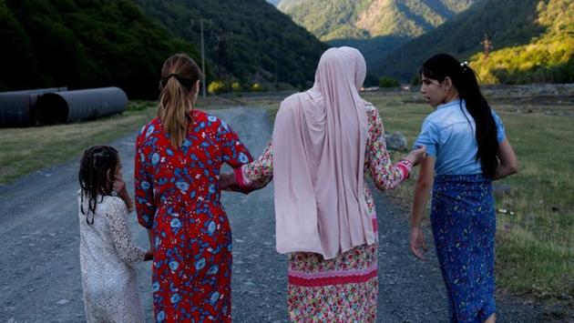 Mariam Kebadze (2L), 16, and her cousins go for a walk along Alazani river in Dzebakhevi village of Pankisi. The three girls live in Grozny, Chechnya and came to Pankisi for the first time and are spending summer here. “I love my cousins and we have a lot of fun but I think they are still very immature and we can’t talk about many things,“ Mariam said. (Ekaterina Anchevskaya / REUTERS)