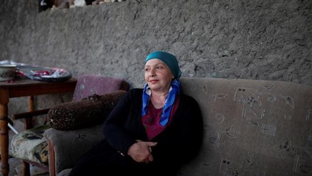 Bela Mutoshvili, 55, a music teacher, and guesthouse owner, sits outside her Folk Guesthouse in Jokolo village. “Developing tourism is the only way for the village to survive now, there are no jobs here,” Mutoshvili said. “I have a group of very talented students but I’m afraid if they get married young they give will up music and their dreams. They are very ambitious and want to continue studying in conservatory, I support them as much as I can.” (Ekaterina Anchevskaya / REUTERS)