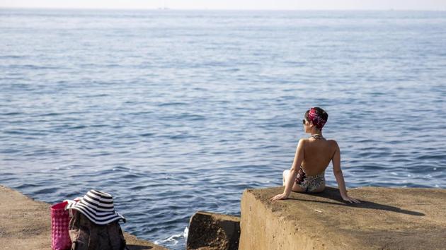 A woman sits on a breakwater in front of the Mediterranean sea in Barcelona, on July 25, 2019. Parts of Europe saw record-high temperatures on Thursday as much of the continent was trapped in a heat wave, the second in two months. (AP) A woman sits on a breakwater in front of the Mediterranean sea in Barcelona, on July 25, 2019. Parts of Europe saw record-high temperatures on Thursday as much of the continent was trapped in a heat wave, the second in two months. (AP)