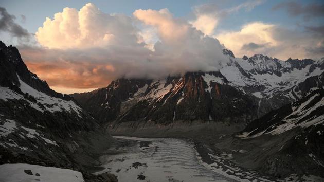 The glacier during sunset. The once immaculate pristine surface on the glacier is now depressed and greyish. Workers have now draped white tarpaulins held in place with large stones over the ice tunnel in a bid to protect it from the sun. (Marco Bertorello / AFP) The glacier during sunset. The once immaculate pristine surface on the glacier is now depressed and greyish. Workers have now draped white tarpaulins held in place with large stones over the ice tunnel in a bid to protect it from the sun. (Marco Bertorello / AFP)