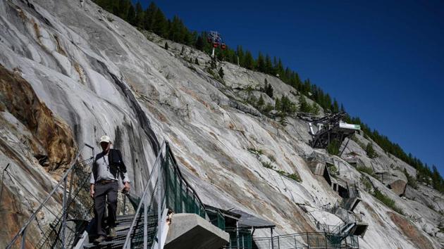 Most spectacular of these rockfalls affected the Bonatti pillar, a massive rock column named after Italian climber Walter Bonatti, that collapsed into a cloud of dust in June 2005. In 2011, smaller collapses also hit the same area and four years later landslides in the Couloir du Gouter prevented hundreds of mountaineers climbing Mont Blanc by the usual busiest routes. More falls have followed. (Marco Bertorello / AFP) Most spectacular of these rockfalls affected the Bonatti pillar, a massive rock column named after Italian climber Walter Bonatti, that collapsed into a cloud of dust in June 2005. In 2011, smaller collapses also hit the same area and four years later landslides in the Couloir du Gouter prevented hundreds of mountaineers climbing Mont Blanc by the usual busiest routes. More falls have followed. (Marco Bertorello / AFP)