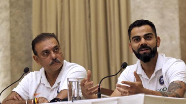 Indian cricket team coach Ravi Shastri, left, looks on as captain Virat Kohli addresses a press conference.(AP)