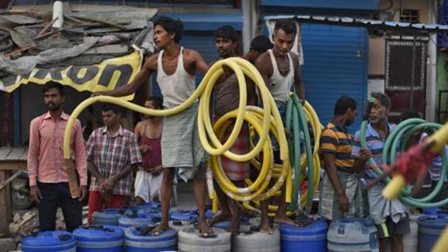 New Delhi, India - June 12, 2019: People wait for their turn to fill empty containers with water using lengths of hose pipe from a Delhi Jal Board tanker, at Sanjay Colony in Okhla Phase II, in New Delhi, India, on Wednesday, June 12, 2019. (Photo by Burhaan Kinu/ Hindustan Times)(Burhaan Kinu/HT PHOTO)