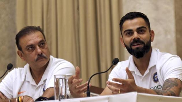 Indian cricket team coach Ravi Shastri, left, looks on as captain Virat Kohli addresses a press conference ahead of the team's departure to West Indies in Mumbai, India, Monday, July 29, 2019.(AP)