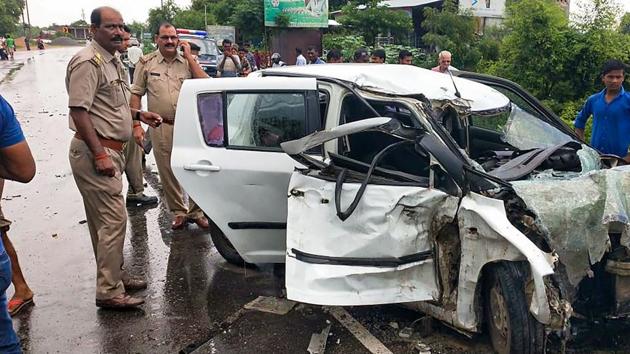 Police and people stand near the wreckage of the car in which the Unnao rape survivor was travelling during its collision with a truck near Raebareli on Sunday, July 28, 2019. The rape survivor, who had accused BJP MLA Kuldeep Sengar of raping her, got seriously injured, while her aunt and lawyer died in the road accident.(Photo: PTI)