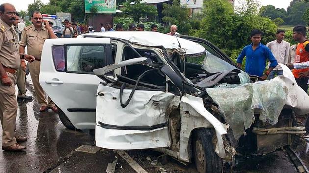 Police and people stand near the wreckage of the car in which the Unnao rape survivor was travelling during its collision with a truck near Raebareli, Sunday, July 28, 2019.(PTI)