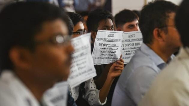 Resident and junior doctors protesting against the NMC bill at AIIMS hospital on Thursday. The IMA also opposes the decision to introduce a common final-year MBBS examination, to be known as the National Exit Test (NEXT), by scrapping the NEET-PG and regulation of fees by the NMC for 50% seats in private medical colleges and deemed universities. (Amal KS / HT Photo) 