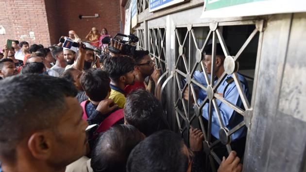Patients gather outside the shut New OPD Block at Lok Nayak Hospital in Delhi during Thursday’s strike against the Lok Sabha passage of the NMC Bill which has nearly 20,000 resident doctors and students striking. The bill is the biggest reform in medical education in the past two or three decades, Union Health Minister Harsh Vardhan said in the Rajya Sabha on Thursday where the bill is under consideration. (Sanchit Khanna / HT Photo) 