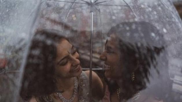 Pictures show Anjali Chakra from India and Sundas Malik from Pakistan under a rain-splattered umbrella.(Twitter/@Sarowarrrr)