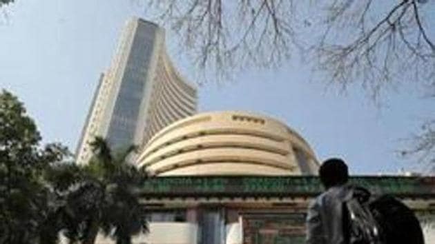 People look at a screen displaying the Sensex results on the facade of the Bombay Stock Exchange (BSE) building in Mumbai.(REUTERS) People look at a screen displaying the Sensex results on the facade of the Bombay Stock Exchange (BSE) building in Mumbai.(REUTERS)