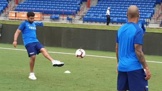 Vice-captain Rohit Sharma kicks a ball as his opening partner Shikhar Dhawan looks on during a training session in Florida. (BCCI/ Twitter)
