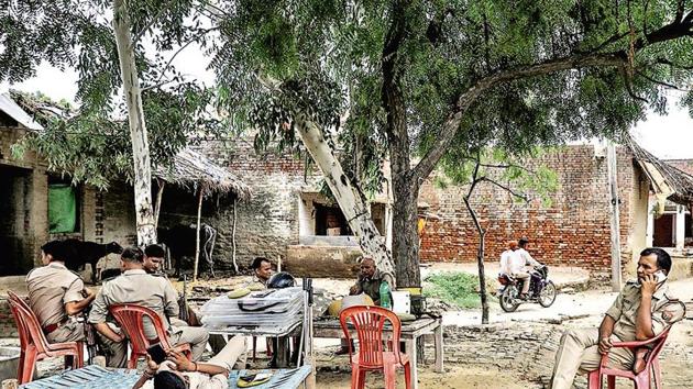 Policemen stand guard at the village of the rape survivor in Uttar Pradesh. (HT FILE) Policemen stand guard at the village of the rape survivor in Uttar Pradesh. (HT FILE)