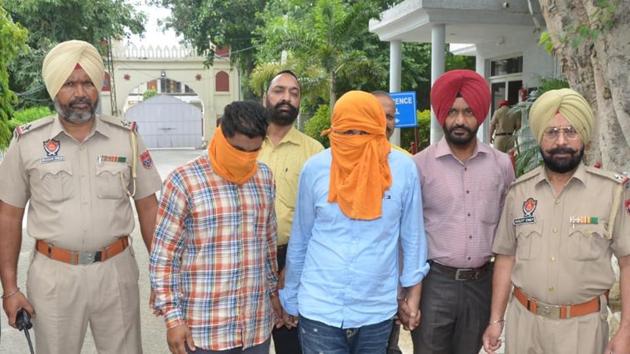 Two men, arrested for smuggling heroin, were produced in a local court in Amritsar on Thursday. August 1, 2019. (HT Photo) Two men, arrested for smuggling heroin, were produced in a local court in Amritsar on Thursday. August 1, 2019. (HT Photo)
