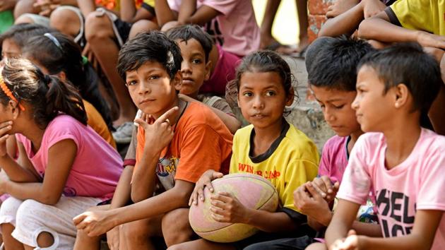 Children sit with a rugby ball near their home in Kidderpore. Future Hope founder Tim Grandage, 60, meanwhile first came to Kolkata in 1987 and was “shocked” by the number of kids on the street. Getting them to play rugby taught them discipline and teamwork, and learning the rules of the game also got many used to a school setting, he says. (Amit Datta / AFP) Children sit with a rugby ball near their home in Kidderpore. Future Hope founder Tim Grandage, 60, meanwhile first came to Kolkata in 1987 and was “shocked” by the number of kids on the street. Getting them to play rugby taught them discipline and teamwork, and learning the rules of the game also got many used to a school setting, he says. (Amit Datta / AFP)