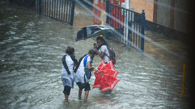 School students enjoy getting drenched as their umbrella loses the fight against heavy rainfall in Mumbai.    (Pramod Thakur/HT Photo ) 