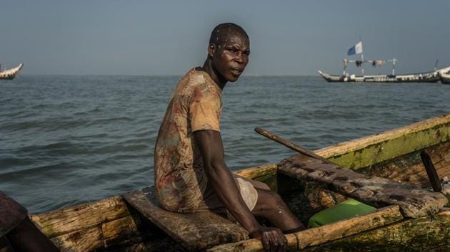 Eric Quaye Ade, a fisherman for almost twenty years, at sea. Ghana is looking to crack down on saiko as well as illegal practices employed by local fishermen including using bright lights to attract fish, chemical poisoning or using dynamite. In a bid to replenish stocks the government banned artisanal fishing this May to June and will forbid trawlers in August and September. (Natalija Gormalova / AFP)